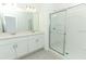Bright bathroom featuring double vanity with white cabinetry and a glass-enclosed shower at 2411 Slippery Rock St, Auburndale, FL 33823