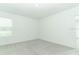 Clean, carpeted bedroom with a window allowing natural light, offering a serene space at 2411 Slippery Rock St, Auburndale, FL 33823