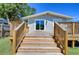 Wooden deck with stairs leading to grassy backyard and house entrance at 829 E Lime St, Lakeland, FL 33801