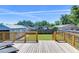 Sunny back deck with wooden railings overlooking a fenced backyard at 829 E Lime St, Lakeland, FL 33801