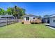 Grassy backyard featuring deck area perfect for relaxation and outdoor enjoyment at 829 E Lime St, Lakeland, FL 33801