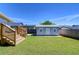 Detached storage shed or garage, with a well-maintained grassy yard at 829 E Lime St, Lakeland, FL 33801