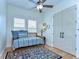 Cozy bedroom with daybed, patterned rug, and abundant natural light from two large windows at 829 E Lime St, Lakeland, FL 33801