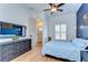 Comfortable bedroom featuring light wood floors, modern ceiling fan, and a spacious layout at 829 E Lime St, Lakeland, FL 33801