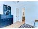 Bedroom featuring decoratively painted black cabinet, artwork, and wood floors at 829 E Lime St, Lakeland, FL 33801