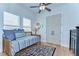 Cozy bedroom with daybed, patterned rug, and abundant natural light from two large windows at 829 E Lime St, Lakeland, FL 33801