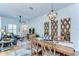 Open-concept dining area with a large wooden table and decorative mirrors, perfect for entertaining guests at 829 E Lime St, Lakeland, FL 33801