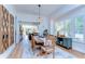 Open dining room with a rustic wooden table, stylish chandelier, and lots of natural light at 829 E Lime St, Lakeland, FL 33801