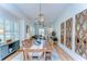 Bright dining area featuring a wooden table, accent mirrors, and access to the cozy living room at 829 E Lime St, Lakeland, FL 33801