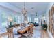 Inviting dining room filled with natural light, featuring a wooden table and a view into the living area at 829 E Lime St, Lakeland, FL 33801