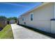 Exterior side view of home featuring long driveway, garage, and fenced in yard at 829 E Lime St, Lakeland, FL 33801