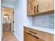 Hallway featuring wood floors, wood cabinets with granite counter tops, and full bathroom at 829 E Lime St, Lakeland, FL 33801