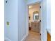 Hallway featuring view of the bathroom, wood floors, and wood cabinets with granite counter tops at 829 E Lime St, Lakeland, FL 33801