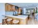 Eat-in kitchen with granite counters, modern cabinets, and three stools at bar at 829 E Lime St, Lakeland, FL 33801