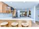 Kitchen with granite counters, breakfast bar, and wood cabinets at 829 E Lime St, Lakeland, FL 33801