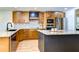 Contemporary kitchen with granite countertops, stainless steel appliances, and light wood cabinetry at 829 E Lime St, Lakeland, FL 33801