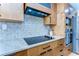 Sleek kitchen with modern appliances, granite countertops, and updated cabinetry with stylish backsplash at 829 E Lime St, Lakeland, FL 33801