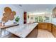 Modern kitchen with stone countertops, wood cabinets, and a decorative wall feature at 829 E Lime St, Lakeland, FL 33801