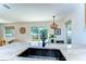 Modern kitchen featuring a sink with backyard views and stylish light fixture at 829 E Lime St, Lakeland, FL 33801