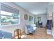 Inviting living area featuring wood floors, stylish seating, and ample natural light from a large window at 829 E Lime St, Lakeland, FL 33801