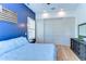 Comfortable main bedroom showcasing blue accent wall, spacious closet, and light wood floors at 829 E Lime St, Lakeland, FL 33801