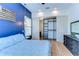 Comfortable main bedroom showcasing blue accent wall, spacious closet, and light wood floors at 829 E Lime St, Lakeland, FL 33801