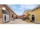 Charming outdoor marketplace with red umbrellas, potted plants and store fronts at 2724 Calabria, Davenport, FL 33897