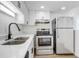 Updated kitchen with stainless steel appliances, double sink, white cabinets, and sleek countertops at 4215 S Semoran Blvd # 3, Orlando, FL 32822