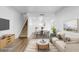 Open-concept living room showcasing the staircase and dining area, enhanced with stylish finishes at 4215 S Semoran Blvd # 3, Orlando, FL 32822