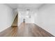 Open-concept living room featuring hardwood floors and a view of the staircase and modern kitchen at 4215 S Semoran Blvd # 3, Orlando, FL 32822