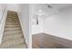 Open living room with view of staircase and modern kitchen with hardwood floors and recessed lighting at 4215 S Semoran Blvd # 3, Orlando, FL 32822