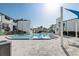 Exterior of community pool, with blue water, lounge chairs, and nearby buildings at 4215 S Semoran Blvd # 3, Orlando, FL 32822