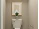 Neutral bathroom featuring a standard toilet, stylish wall art, and simple hardware at 951 Hour Glass Rd, Lakeland, FL 33801