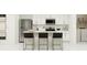 Modern kitchen with stainless steel appliances, an island with seating, and sleek white cabinetry at 951 Hour Glass Rd, Lakeland, FL 33801