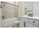 Bright bathroom featuring a shower over the tub and a white vanity with black hardware at 3158 Sailing Pier Ave, Winter Garden, FL 34787