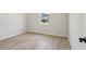 Empty bedroom with light gray walls, wood-look tile floors, and a window at 3158 Sailing Pier Ave, Winter Garden, FL 34787