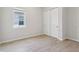 Cozy bedroom with a window, closet, and wood-look tile flooring at 3158 Sailing Pier Ave, Winter Garden, FL 34787