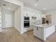 Modern kitchen with stainless appliances, a center island, and plenty of cabinet space at 3158 Sailing Pier Ave, Winter Garden, FL 34787