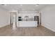 Bright kitchen featuring white cabinetry, stainless steel appliances, and a large central island at 3158 Sailing Pier Ave, Winter Garden, FL 34787