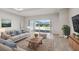 Cozy living room with a sliding glass door, stylish decor, and a comfortable seating area at 3158 Sailing Pier Ave, Winter Garden, FL 34787
