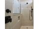 Shower with gray tiled walls, black fixtures and accents, and glass partition at 3158 Sailing Pier Ave, Winter Garden, FL 34787
