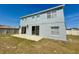 Backyard of home with grass and patio, featuring sliding glass doors at 539 Lakeview Dr, Poinciana, FL 34759
