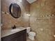 Bathroom featuring granite counters, a dark wood vanity, and brown patterned tiles at 539 Lakeview Dr, Poinciana, FL 34759