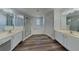 Elegant bathroom featuring dual sinks, a luxurious tub, and a separate glass-enclosed shower at 539 Lakeview Dr, Poinciana, FL 34759