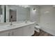 Bright bathroom featuring double sinks, white cabinets, and a tub with white tiles at 539 Lakeview Dr, Poinciana, FL 34759