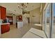 Open-concept living space featuring tile flooring, a modern chandelier, and easy access to kitchen at 539 Lakeview Dr, Poinciana, FL 34759