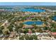 Aerial view of a neighborhood featuring multiple ponds and lakes, surrounded by lush greenery at 934 W Heron Cir, Winter Haven, FL 33884