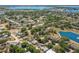 Beautiful aerial view of a lakeside community and home with a screened pool at 934 W Heron Cir, Winter Haven, FL 33884