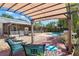 Tranquil backyard oasis featuring a pool, pergola, and tropical landscaping at 934 W Heron Cir, Winter Haven, FL 33884