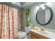 Charming bathroom with a cheerful lemon-themed shower curtain and decorative accents at 934 W Heron Cir, Winter Haven, FL 33884